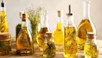 Composition of bottles with oil on wooden table